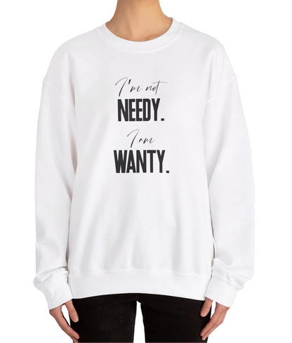 Model wearing a white sweatshirt featuring the phrase "I'm not NEEDY. I'm just WANTY." in bold black text. Part of the Vivid Divergence Sensory Friendly Sweatshirt Range.