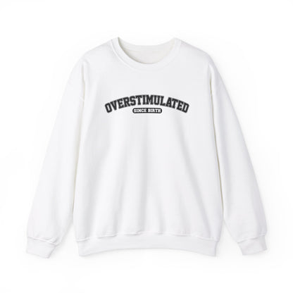 Front view of a white sweater jumper with the text "Overstimulated Since Birth" in bold black lettering. Part of the Vivid Divergence Sensory Friendly Unisex Sweater Jumper Range.