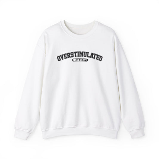 Front view of a white sweater jumper with the text "Overstimulated Since Birth" in bold black lettering. Part of the Vivid Divergence Sensory Friendly Unisex Sweater Jumper Range.