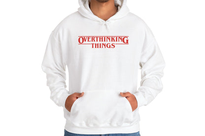 Model wearing a white hoodie featuring the text "Overthinking Things" in the iconic Stranger Things font and style. Part of the Vivid Divergence Sensory Friendly Unisex Hoodie Range.