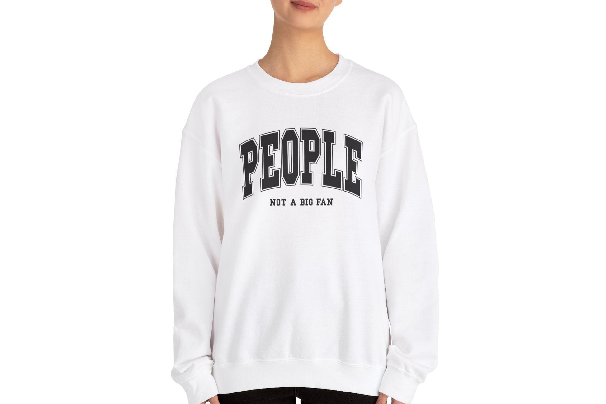 Model wearing a white sweater jumper with the text "People. Not a Big Fan" in bold white lettering. Part of the Vivid Divergence Sensory Friendly Unisex Sweater Jumper Range.