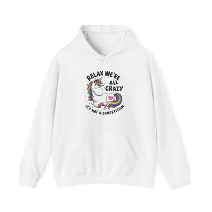 Front view of a white hoodie featuring the text "Relax, We're All Crazy" and a cartoon illustration of a raccoon in a teacup. Part of the Vivid Divergence Sensory Friendly Unisex Hoodie Range. 