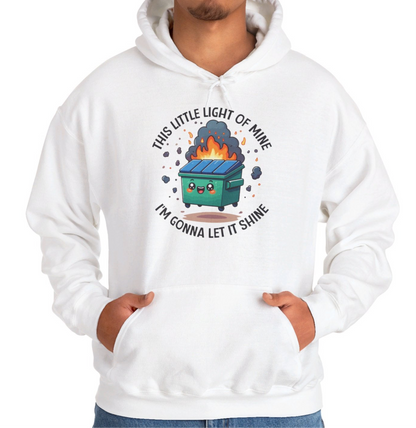 Model wearing a white hoodie featuring the text "This Little Light of Mine, I'm Gonna Let It Shine" and a cartoon illustration of a dumpster fire with glowing flames. Part of the Vivid Divergence Sensory Friendly Unisex Hoodie Range.