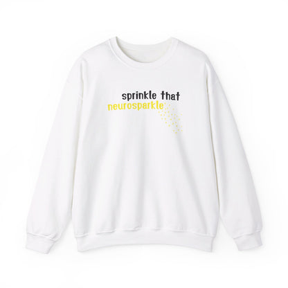 Front view of a white sweater jumper with the text "Sprinkle That Neurosparkle" in yellow and white lettering, surrounded by sparkling star graphics. Part of the Vivid Divergence Sensory Friendly Unisex Sweater Jumper Range.