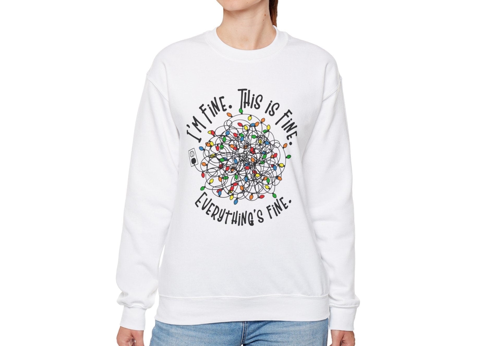 Model wearing a white sweatshirt featuring a humorous tangled Christmas lights design with the phrase "I'm Fine. This is Fine. Everything's Fine." Part of the Vivid Divergence Sensory Friendly Sweatshirt Range.