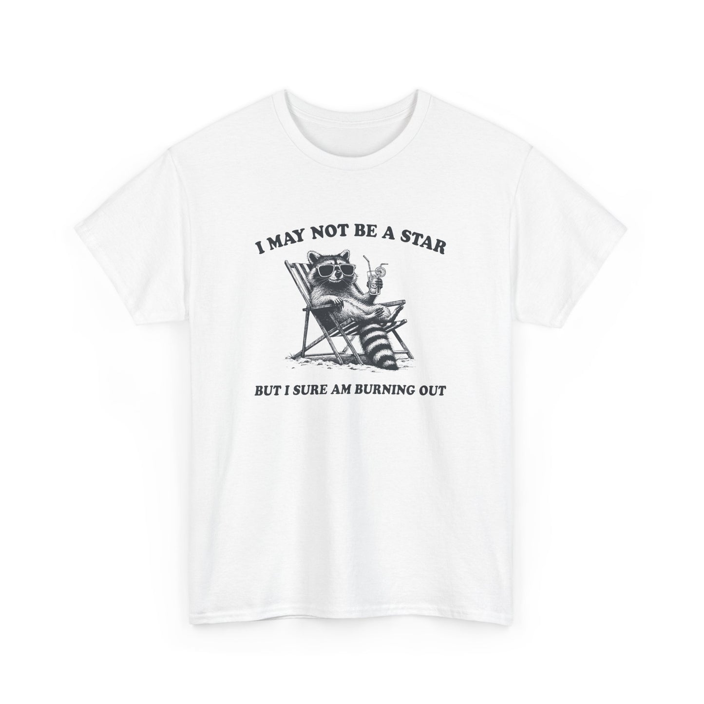 Hanging front view of a white T-shirt featuring a cute raccoon holding a star with text that reads "I May Not Be A Star, But I Sure Am Burning Out." Part of the Vivid Divergence Sensory Friendly Unisex Tees Range.