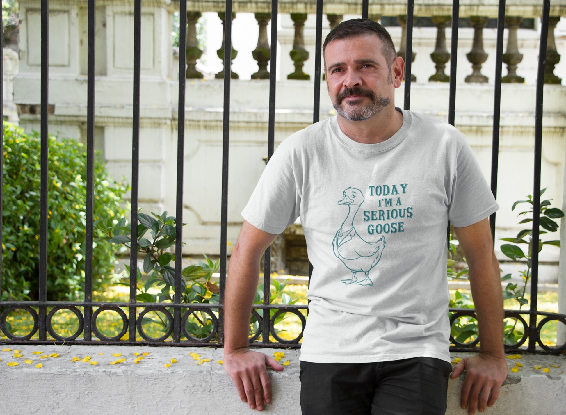 Model wearing a white T-shirt with "Today I'm A Serious Goose" in black text and a simple goose illustration. Part of the Vivid Divergence Sensory Friendly Unisex Tees Range.