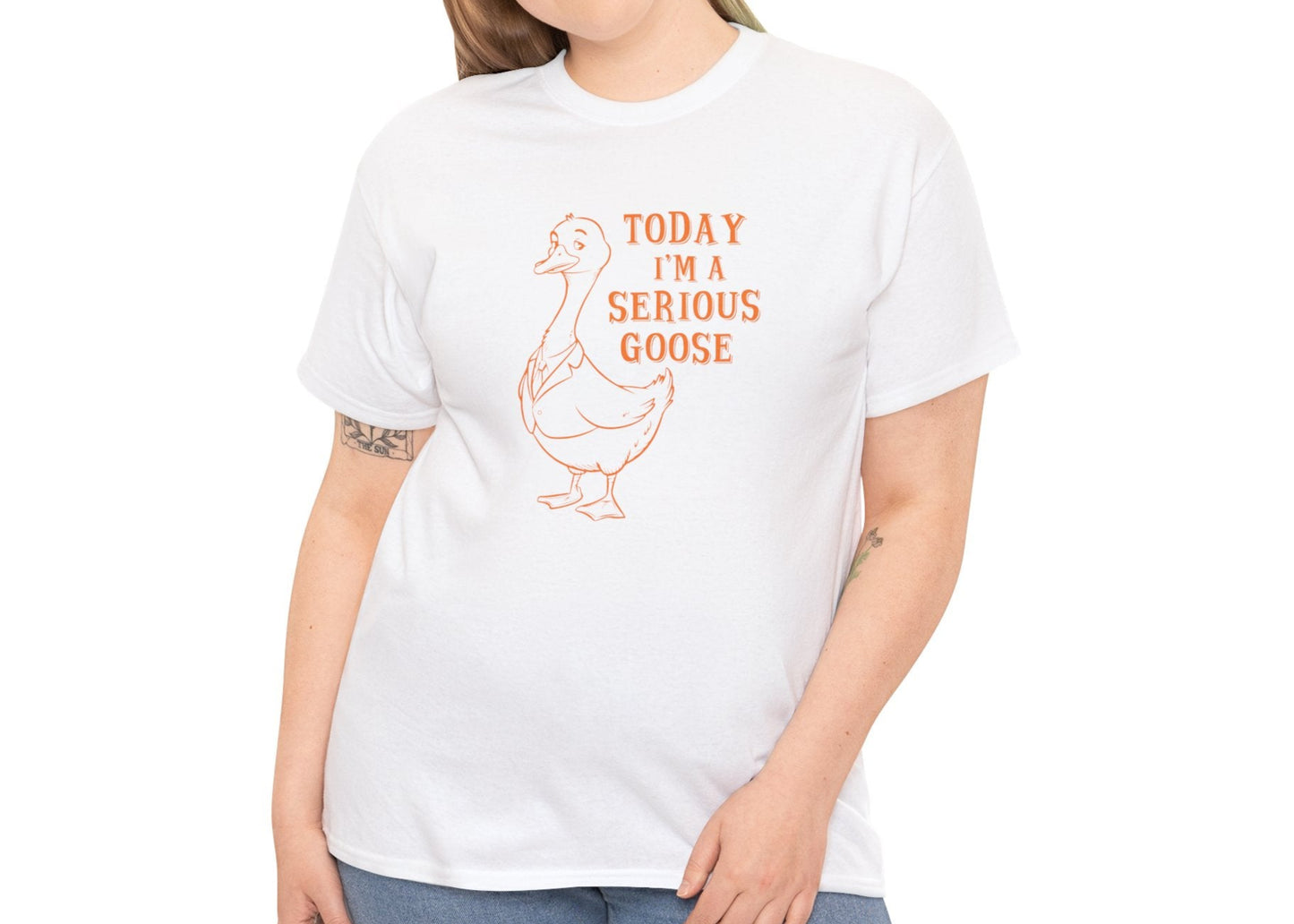 Model wearing a white T-shirt with "Today I'm A Serious Goose" in orange text and a simple goose illustration. Part of the Vivid Divergence Sensory Friendly Unisex Tees Range.