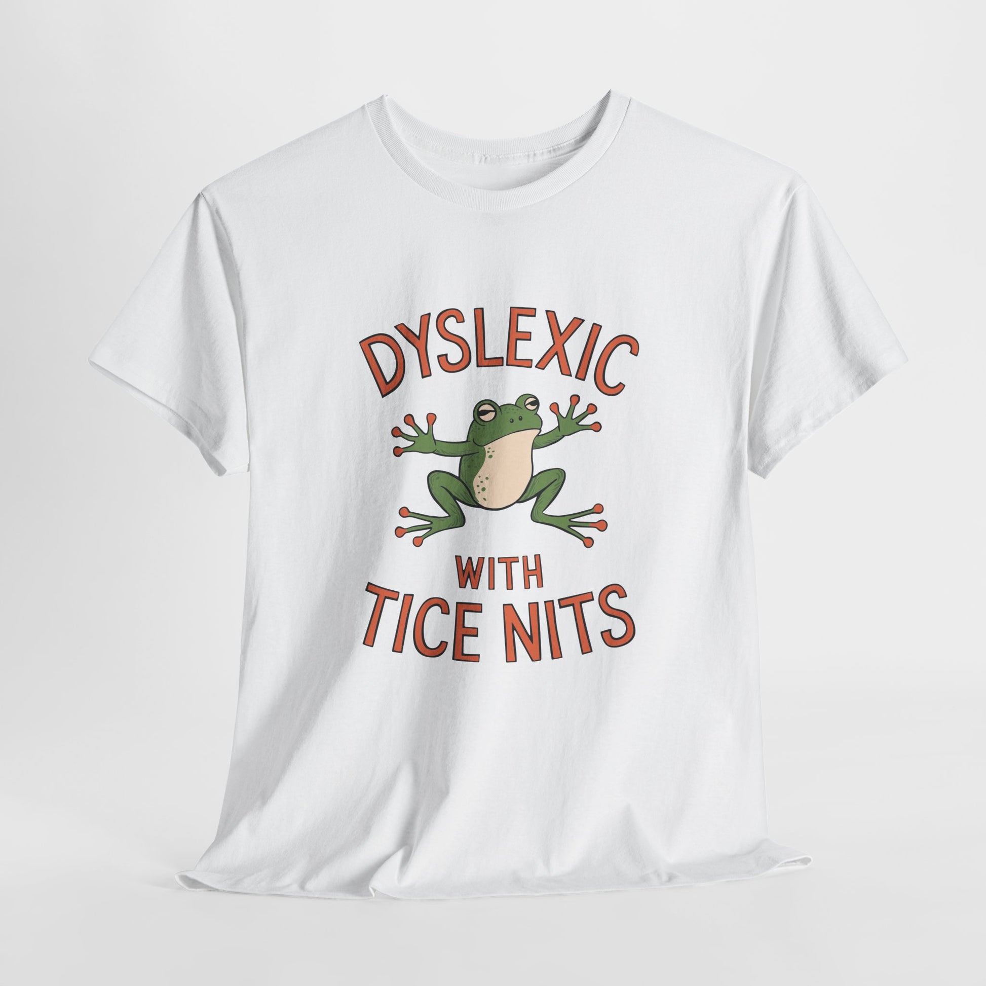 White T-shirt with a graphic of a green frog and the text "Dyslexic with Tice Nits," laid flat. Part of the Vivid Divergence Sensory Friendly Unisex Tees Range.