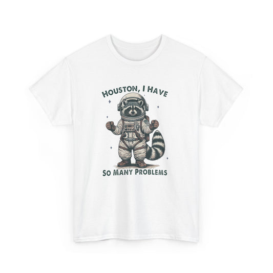 Front view of a white T-shirt featuring a graphic of an astronaut raccoon with the text "Houston, I Have So Many Problems." Part of the Vivid Divergence Sensory Friendly Unisex Tees Range.