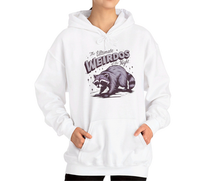 Model wearing a white hoodie featuring the text "The Ultimate Weirdos of the Night" with a cartoon illustration of a raccoon and an opossum. Part of the Vivid Divergence Sensory Friendly Unisex Hoodie Range.