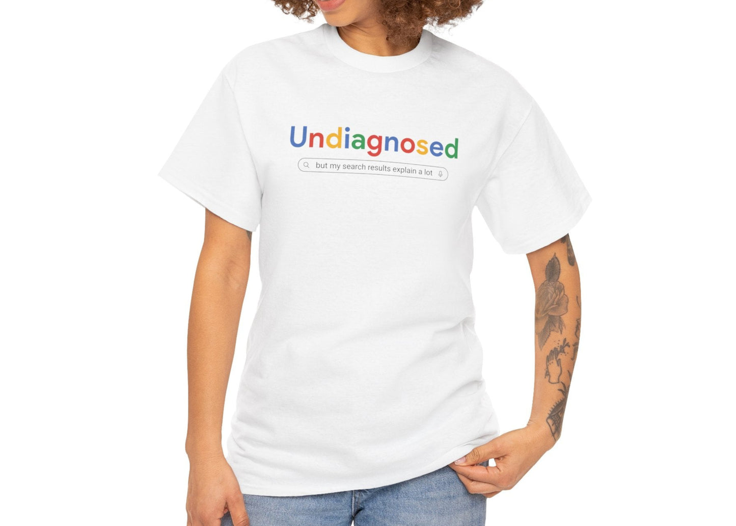 Front view of a white T-shirt with the text "Undiagnosed" in the Google logo font and colors, paired with casual blue jeans. Part of the Vivid Divergence Sensory Friendly Unisex Tees Range.