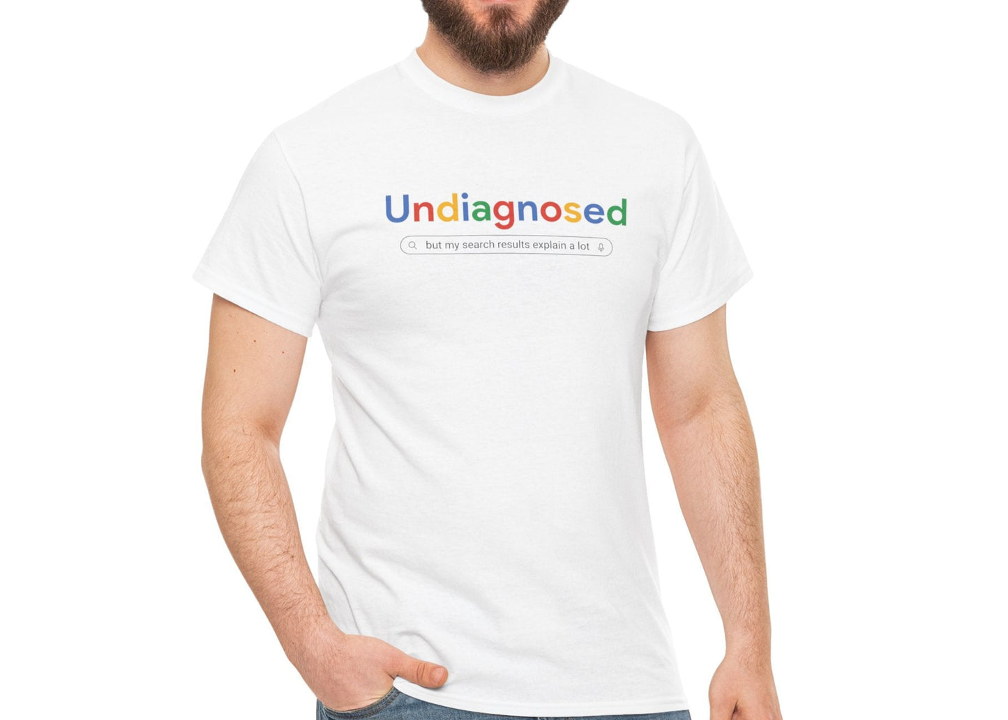 Model wearing a white T-shirt with the text "Undiagnosed" styled in the Google logo font and colors, standing outdoors in a casual setting. Part of the Vivid Divergence Sensory Friendly Unisex Tees Range.