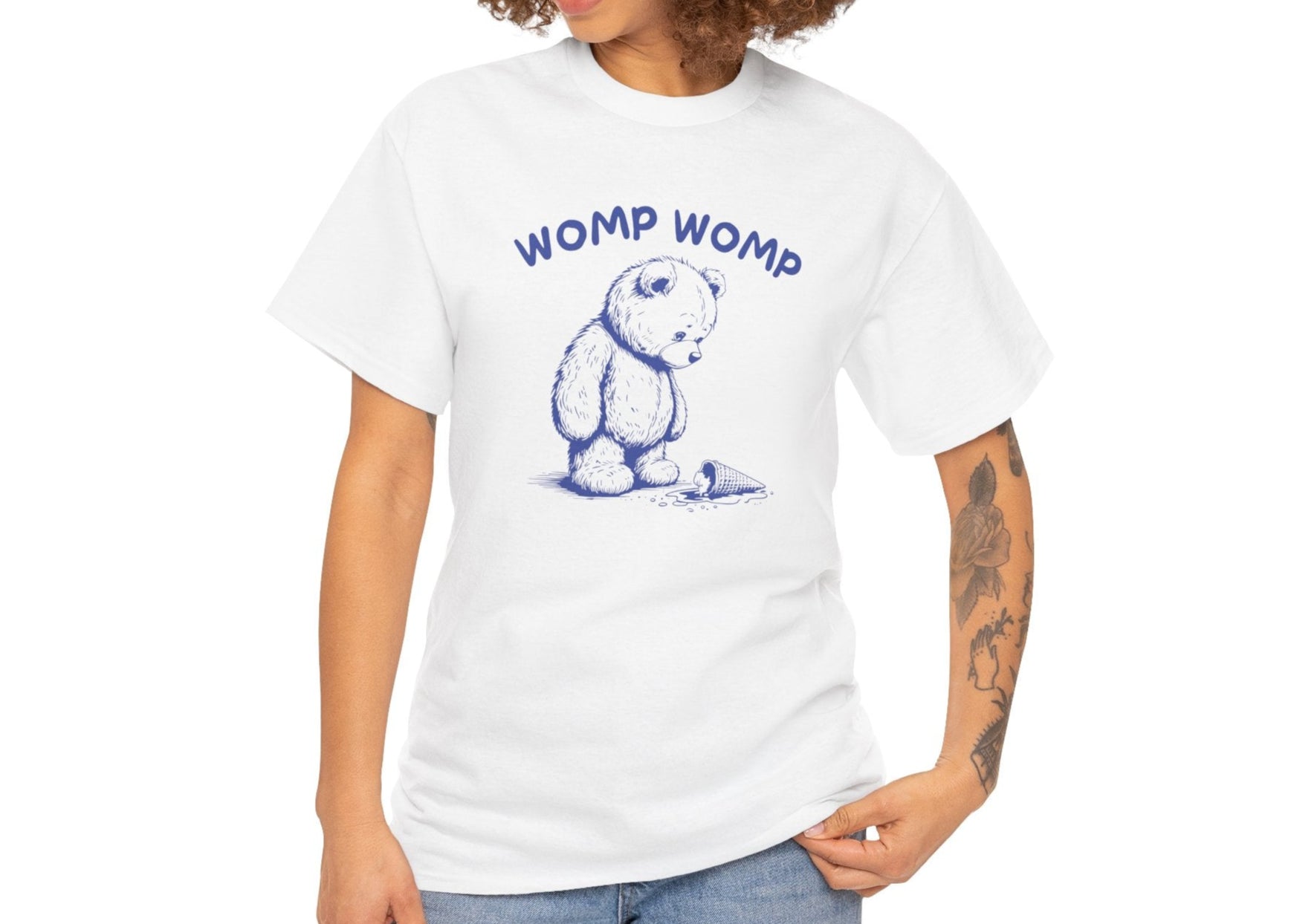 Front view of a white T-shirt featuring "Womp Womp" text with a sad bear looking at a dropped ice cream cone in navy blue-tone design. Part of the Vivid Divergence Sensory Friendly Unisex Tees Range.