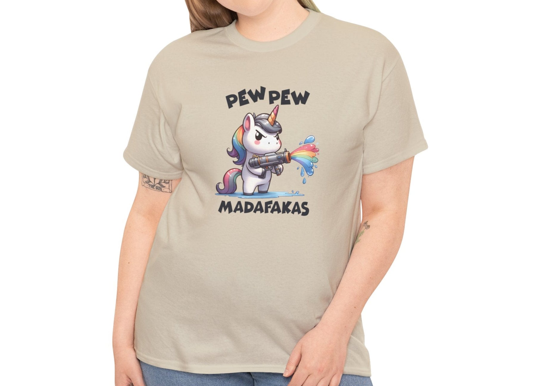 Woman wearing a beige T-shirt with a "Pew Pew Madafakas" unicorn graphic, styled casually. Part of the Vivid Divergence Sensory Friendly Unisex Tees Range.