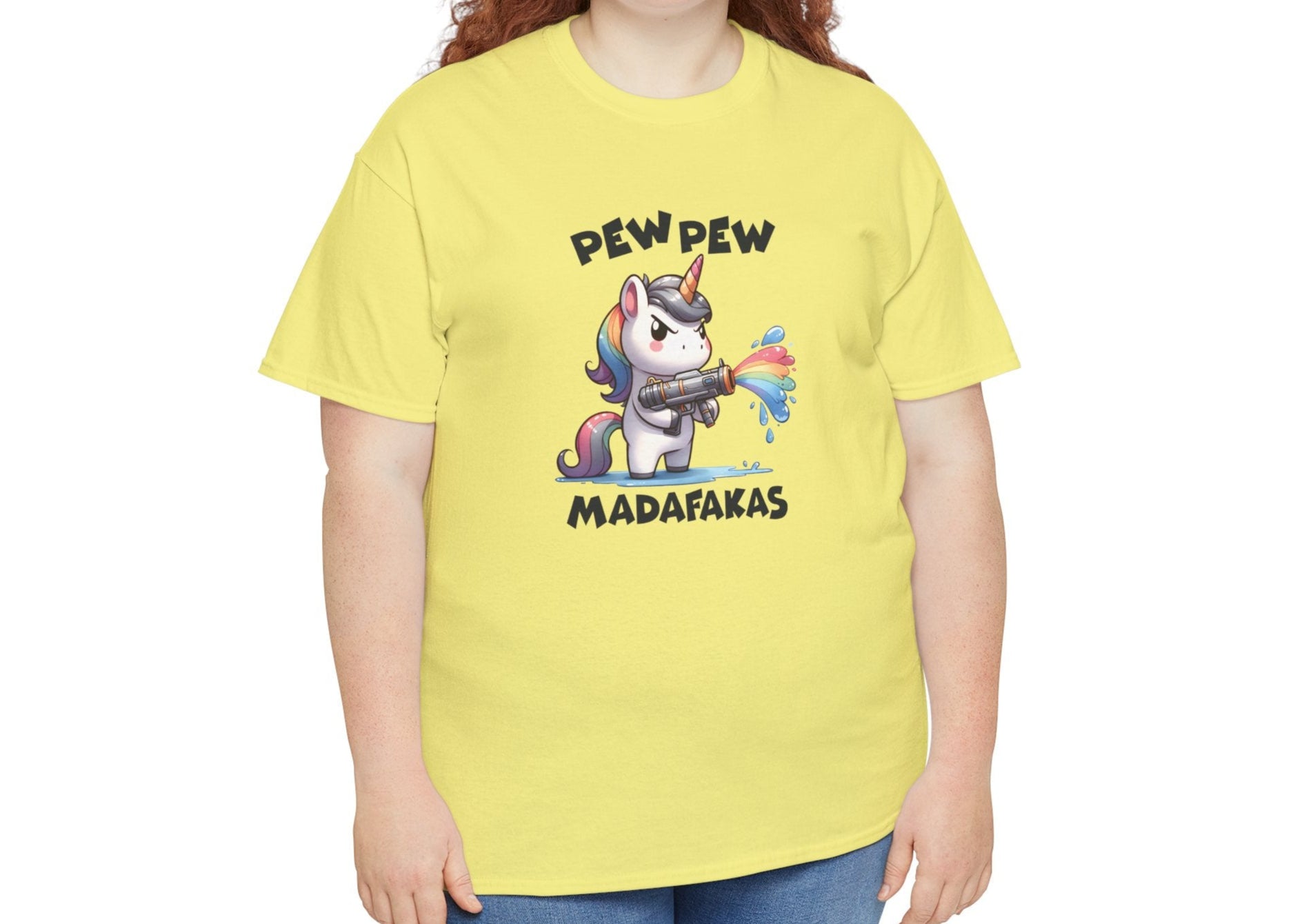 Woman wearing a yellow T-shirt with a "Pew Pew Madafakas" unicorn graphic, styled casually. Part of the Vivid Divergence Sensory Friendly Unisex Tees Range.