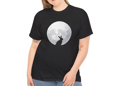 Woman wearing a black Easter T-shirt featuring a rabbit silhouette against a full moon, a stylish and mystical design. Hop into the season in style and shop Easter shirts online today!
