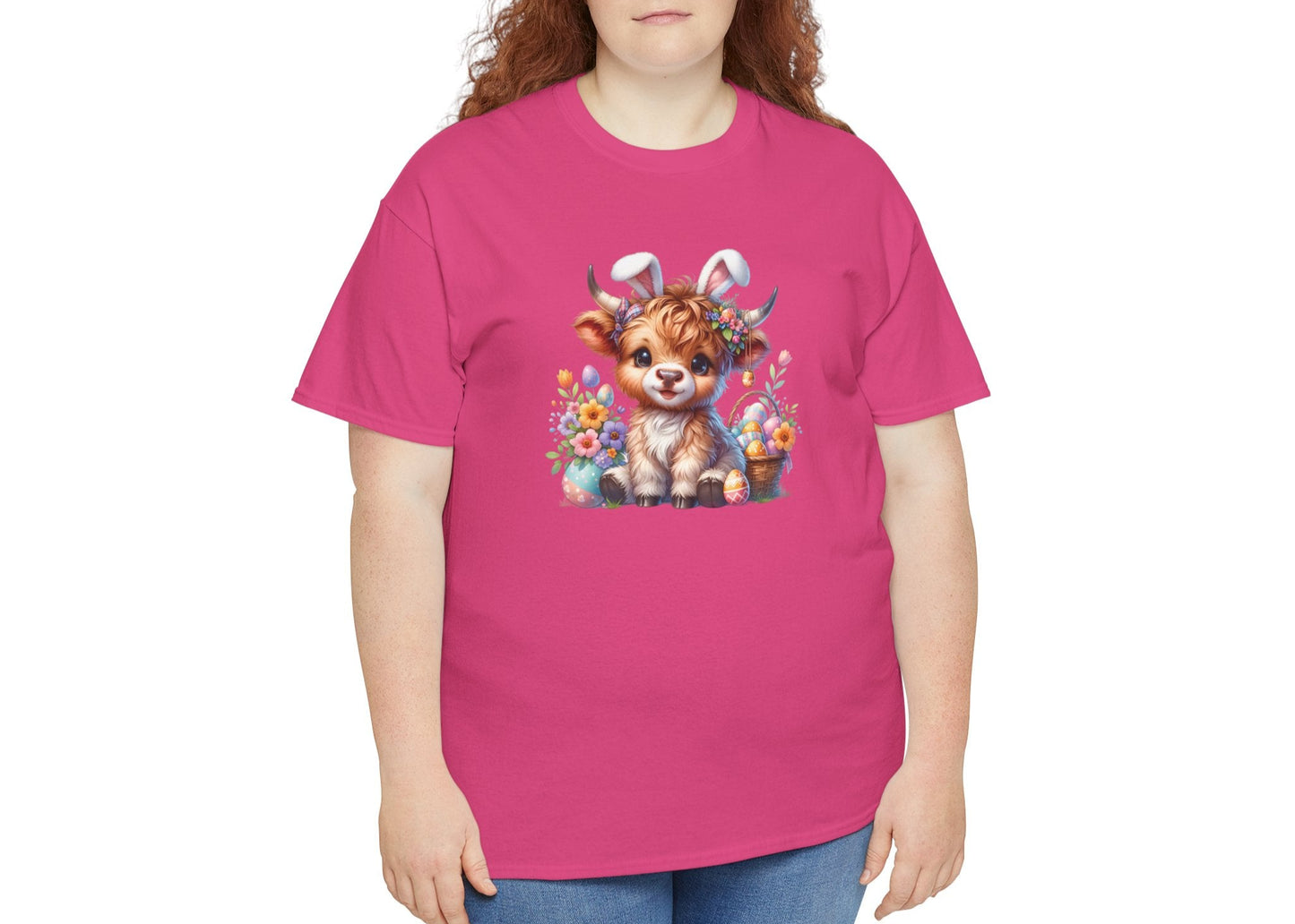 Woman wearing a bright pink Easter T-shirt featuring a fluffy Highland cow with festive accents, perfect for celebrating in style. Hop into the season in style and shop Easter shirts online today!