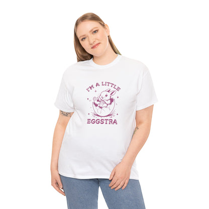Woman wearing a white Easter T-shirt with a bunny and "I'm A Little Eggstra" text, a fun and festive holiday fashion statement. Hop into the season in style and shop Easter shirts online today!