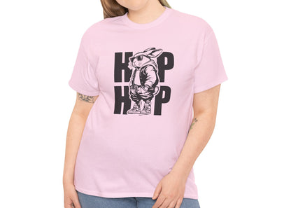Woman wearing a light pink Easter T-shirt showcasing a hip-hop bunny with bold "HOP HOP" text, a trendy holiday look. Hop into the season in style and shop Easter shirts online today!