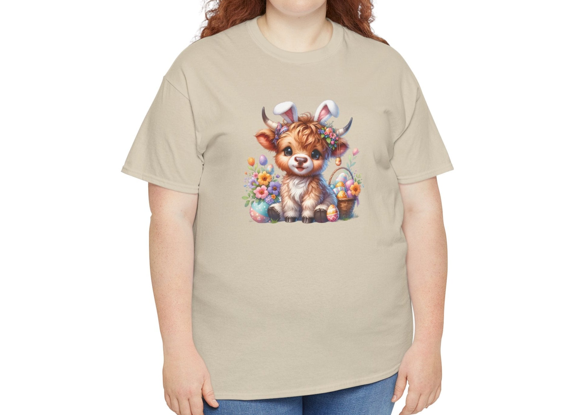 Woman wearing a sand Easter T-shirt featuring a rustic Highland cow with Easter decorations, ideal for a country-style spring outfit. Hop into the season in style and shop Easter shirts online today!