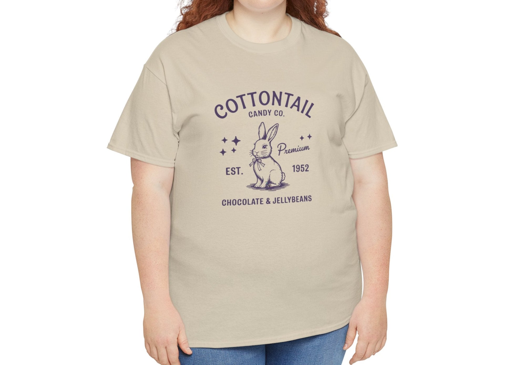 Woman wearing a sand Easter T-shirt featuring an old-school "Cottontail Candy Co." bunny logo, adding timeless elegance to Easter fashion. Hop into the season in style and shop Easter shirts online today!