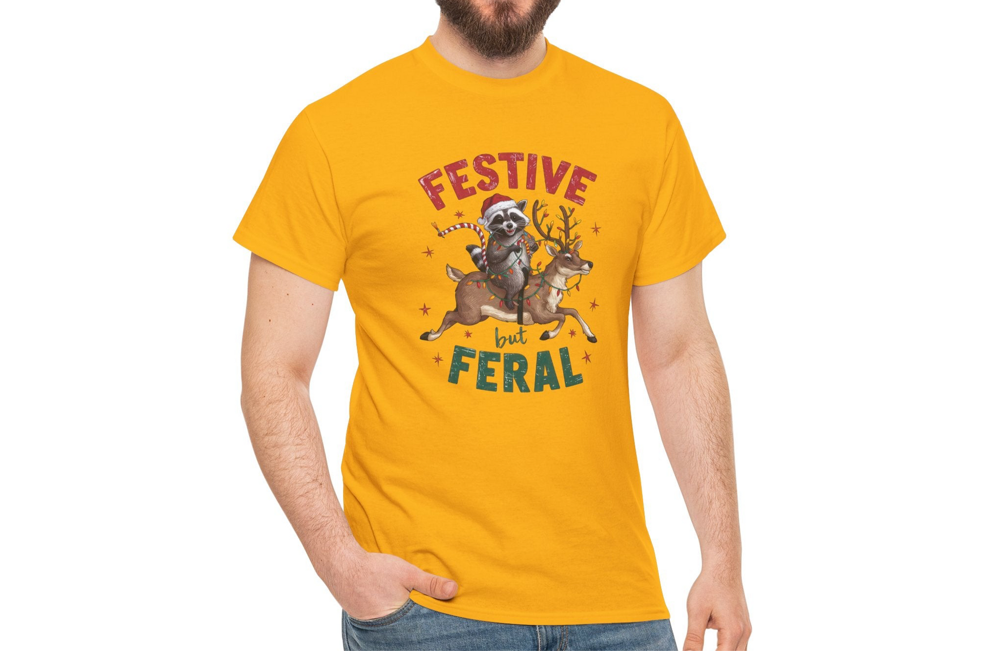 Model wearing a yellow T-shirt featuring a festive illustration of a raccoon holding Christmas lights and the text "Festive but Feral," styled casually for the holidays. Part of the Vivid Divergence Sensory Friendly Unisex Tees Range.