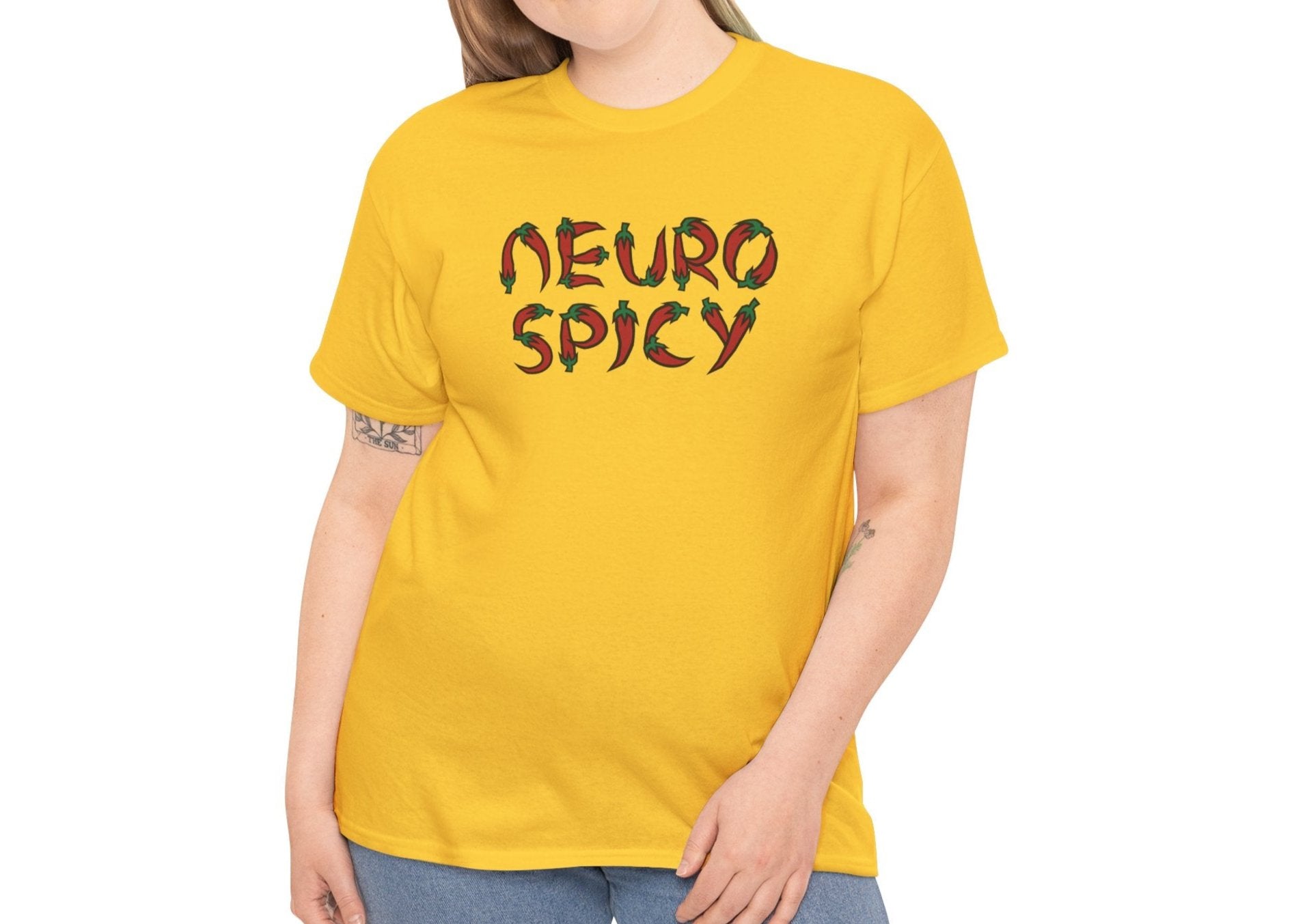 Model wearing a yellow T-shirt with "Neuro Spicy" text, styled casually with jeans. Part of the Vivid Divergence Sensory Friendly Unisex Tees Range.